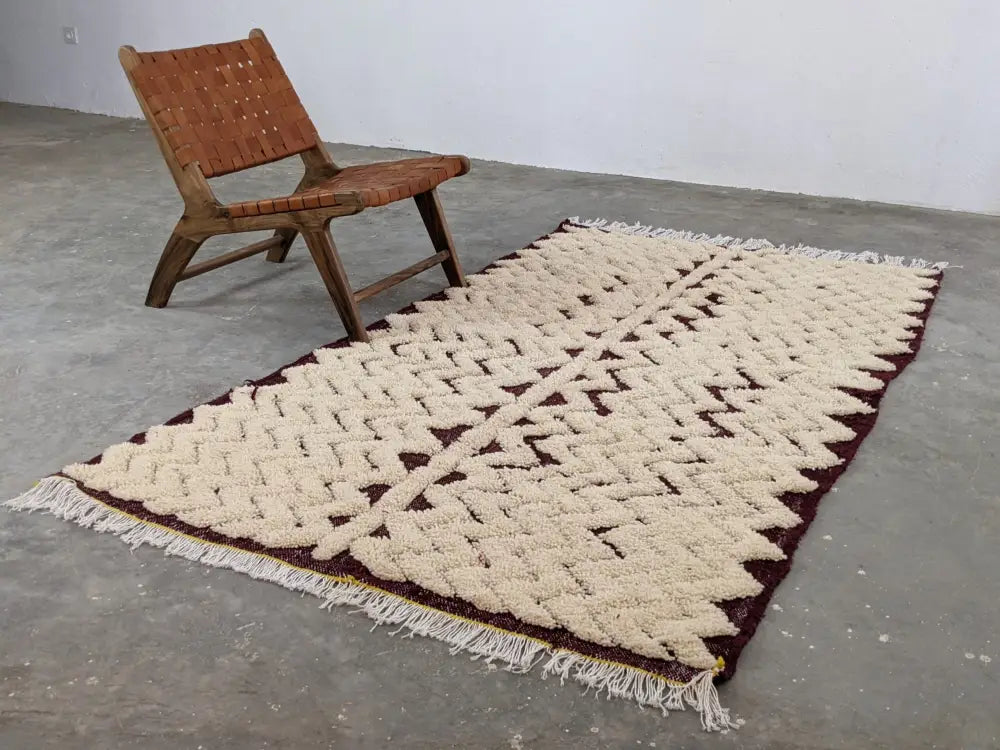 Cream and maroon woven beni ouarain rug with textured geometric pattern and fringed edges moroccan handmade design