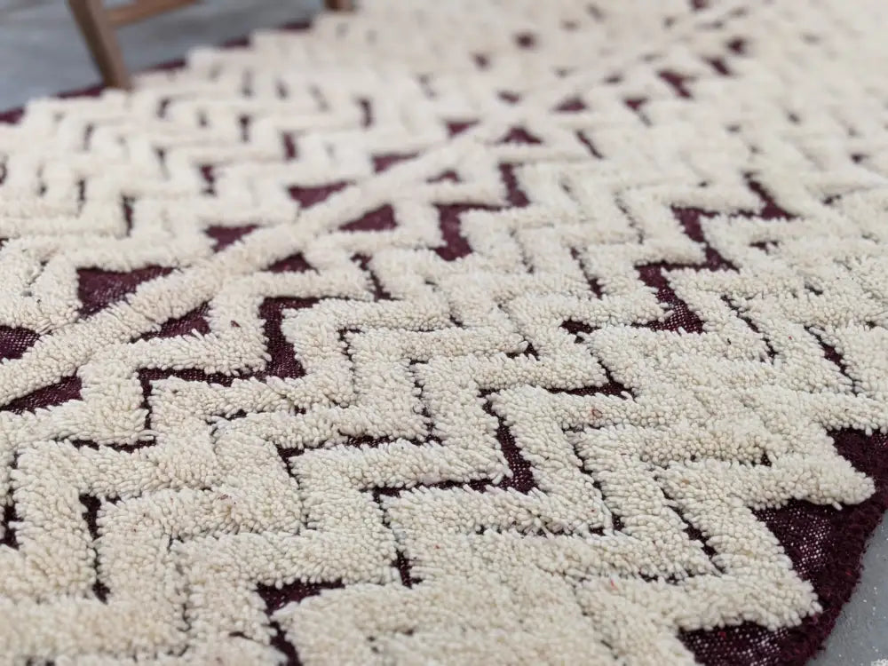Cream-colored plush woven beni ouarain rug with bold geometric pattern on deep burgundy base moroccan handmade
