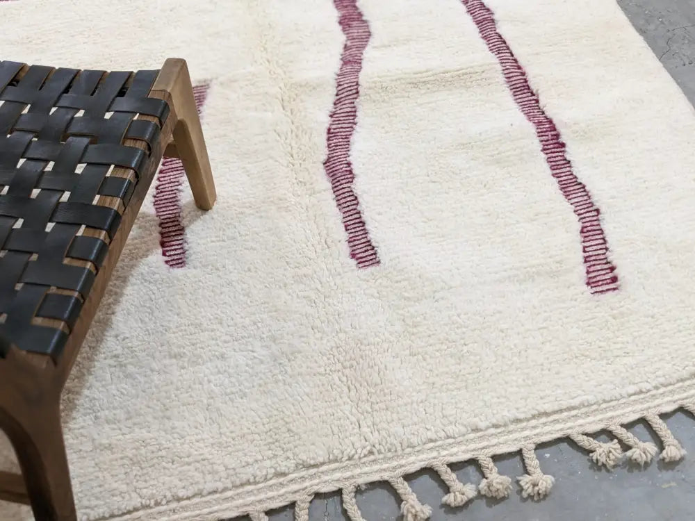 Cream-colored beni ouarain rug with textured hand-knotted design and burgundy stripes moroccan handmade wool rug