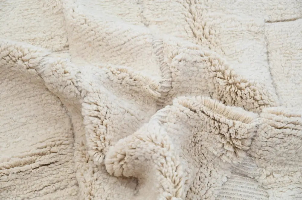 Cream-colored plush beni ouarain rug with textured tufted surface and woven patterns moroccan handmade decor