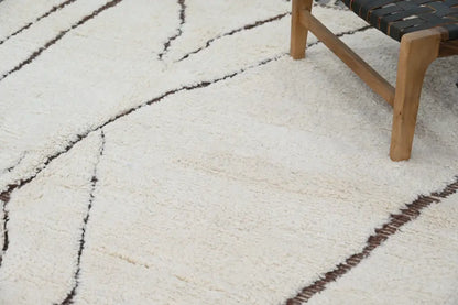 Cream-colored plush shag beni ouarain rug with bold black geometric stripes 290 x 214 cm by DecorBites™