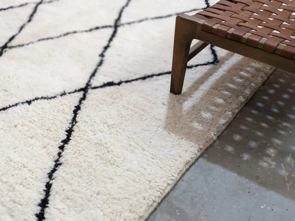 Cream-colored plush wool beni ouarain rug with bold black geometric patterns moroccan handmade traditional design