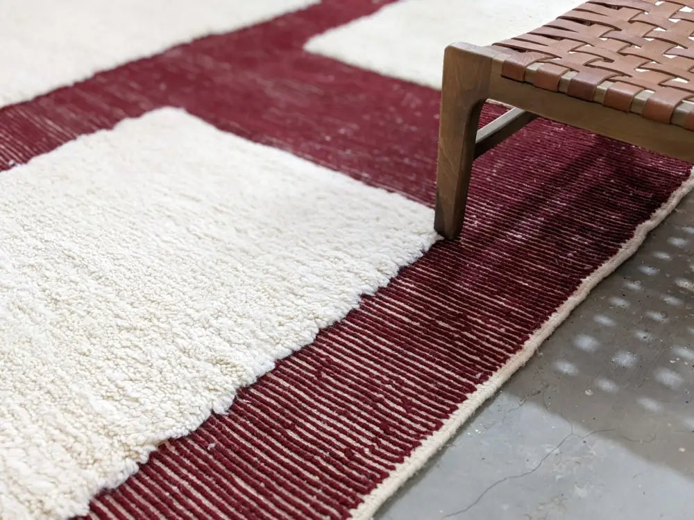 A plush moroccan handmade beni ouarain rug with geometric bold white and deep burgundy patterns 297 x 206 cm
