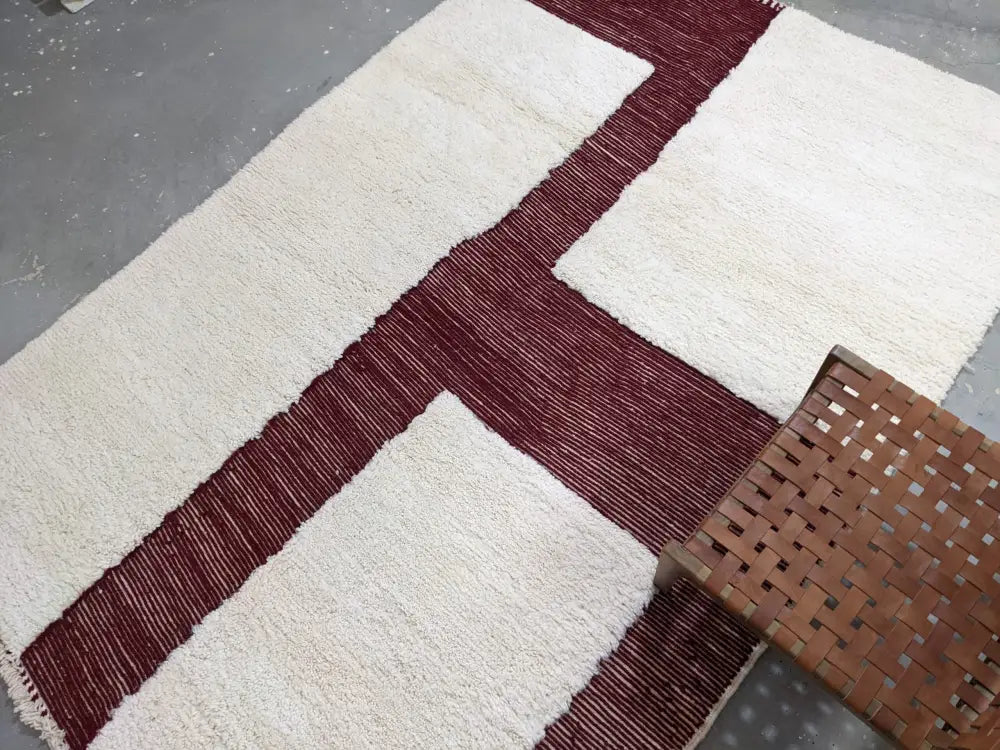 Cream-colored plush wool moroccan handmade beni ouarain rug with bold maroon geometric stripes 297 x 206 cm