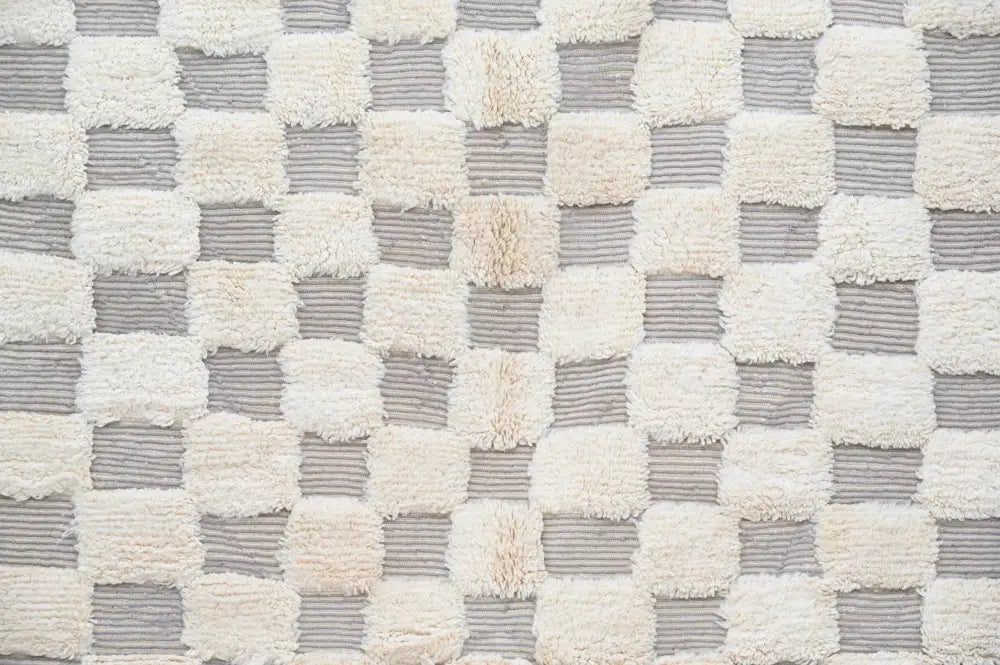 A beni ouarain rug by decorbites featuring a soft cream and gray checkerboard pattern in 300 x 203 cm size