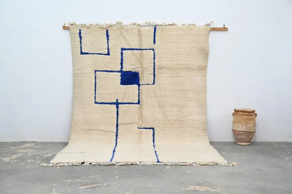 Beige moroccan handmade beni ouarain rug with bold blue geometric patterns and fringed edges 300 x 207 cm