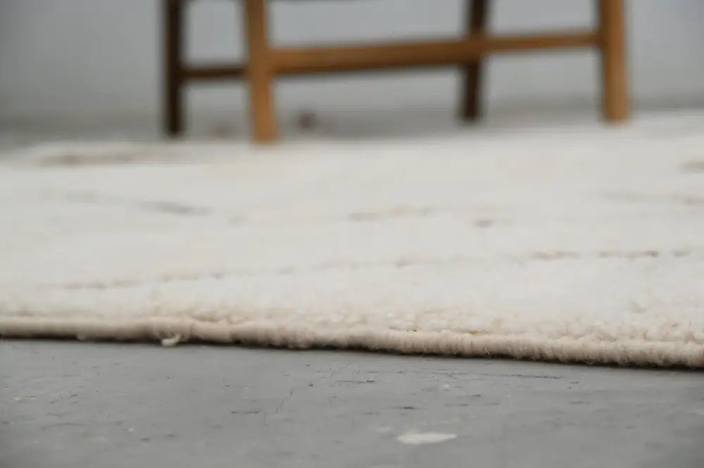 Off-white plush moroccan handmade beni ouarain rug with soft textured surface and neatly finished edges 300 x 210 cm