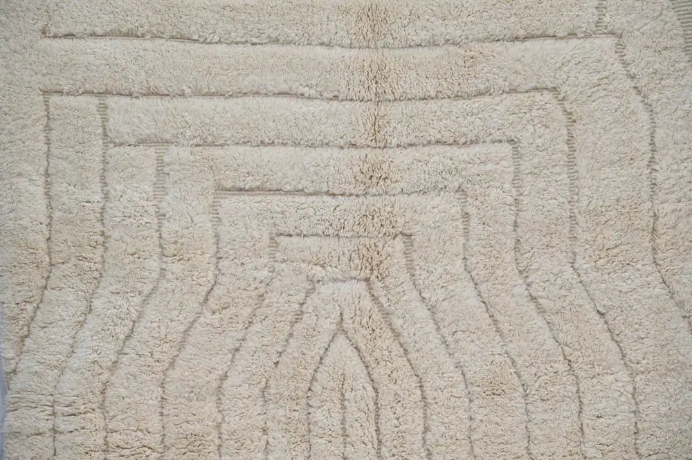 Beige plush decorbites moroccan handmade beni ouarain rug with soft textured surface and concentric arch pattern