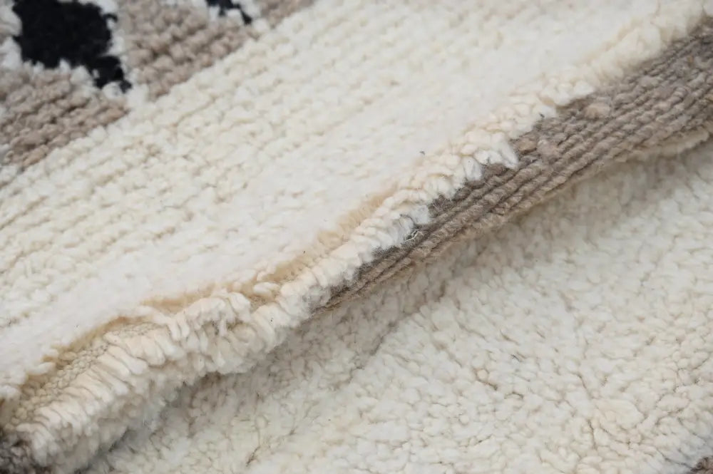 Cream-colored sherpa fabric beni ouarain rug with soft plush texture and subtle beige woven border moroccan handmade design