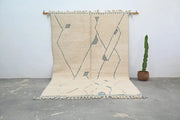 Beige moroccan handmade beni ouarain rug with gray geometric patterns and fringed edges 305 x 205 cm by DecorBites