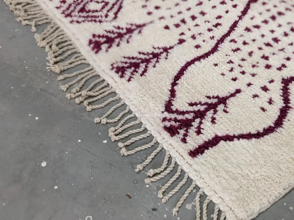 DecorBites™ beni ouarain rug cream with burgundy geometric and leaf patterns and thick fringed edges 307 x 213 cm
