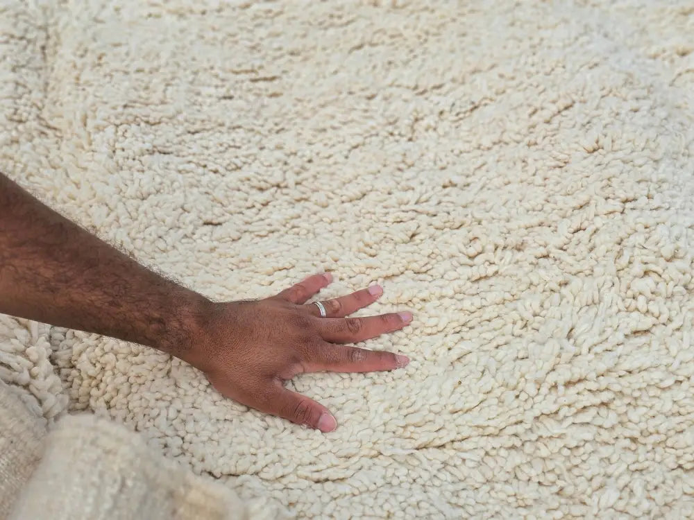 Cream-colored plush shaggy moroccan handmade beni ouarain rug with soft textured surface by decorbites