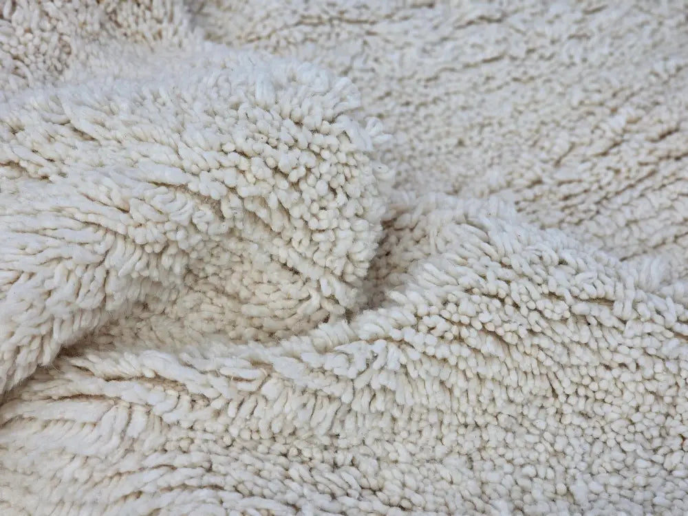 Cream-colored plush fleece fabric with soft texture on moroccan handmade beni ouarain rug 464 x 360 cm by decorbites