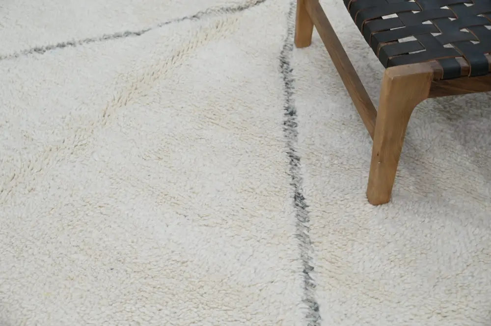 Cream-colored plush wool beni ouarain rugs with subtle black woven stripes moroccan handmade traditional berber rug