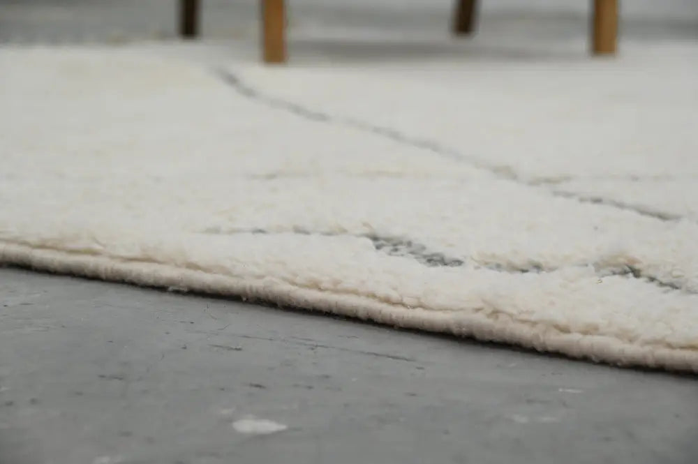 Cream-colored plush shag beni ouarain rug with subtle gray geometric edge pattern moroccan handmade traditional berber