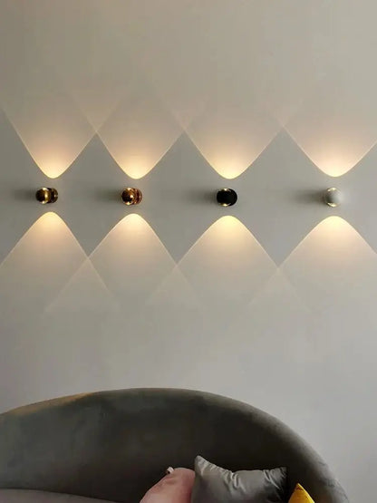 DecorBites™ Moroccan modern black brass led wall lamps with spherical gold and black finishes emitting warm light patterns
