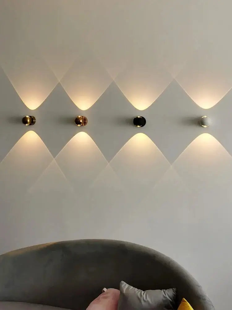 DecorBites™ Moroccan modern black brass led wall lamps with spherical gold and black finishes emitting warm light patterns