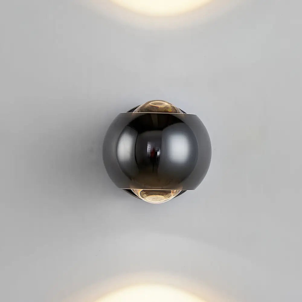 DecorBites™ Moroccan modern black brass led wall lamp with spherical polished surface and amber glass accents