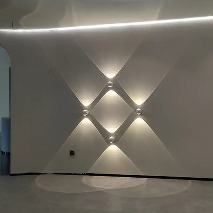 Modern white textured wall featuring decorbites™ moroccan modern black brass led wall lamp with recessed spherical lights arranged in diamond pattern