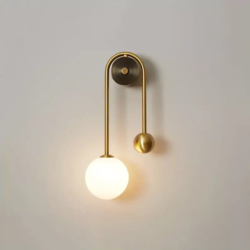 Traditional gold wall sconces with curved metal arms and frosted glass shades as elegant gold wall sconces