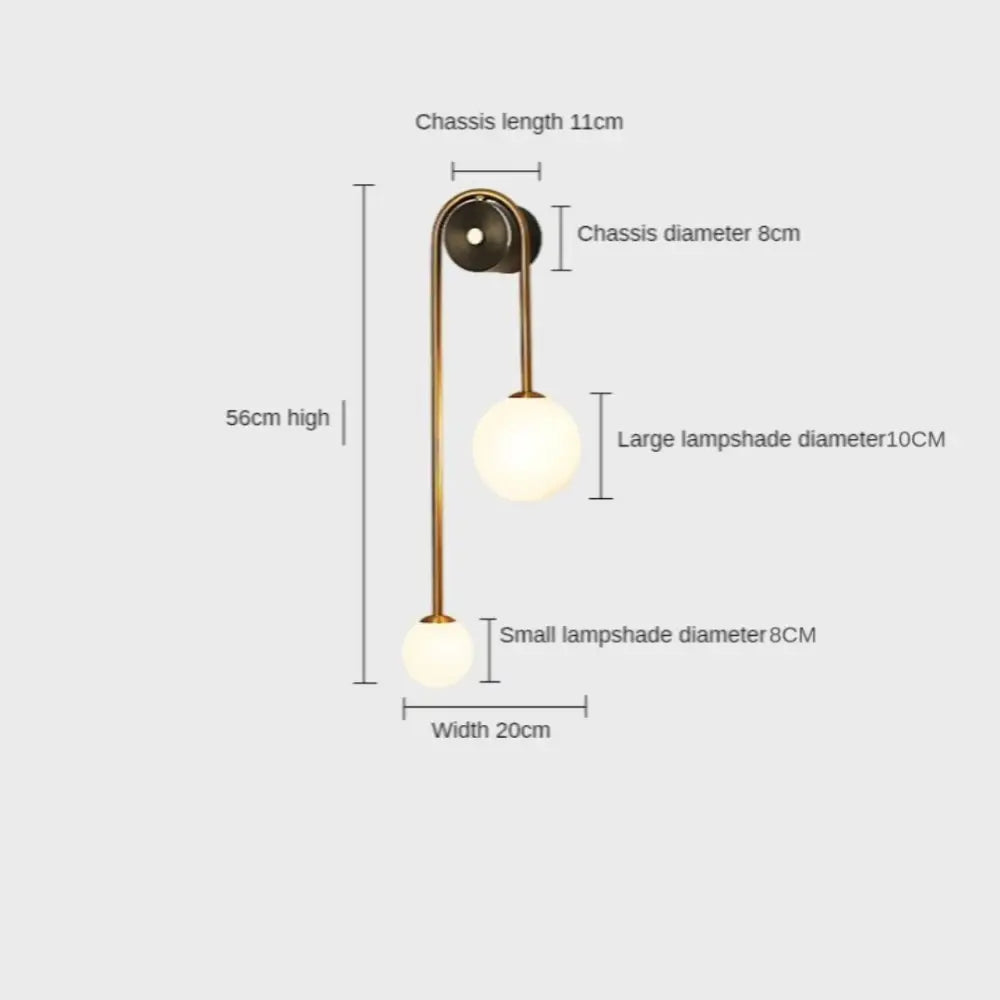 Modern brass-finished gold wall sconces with two spherical glass shades in traditional decorbites style