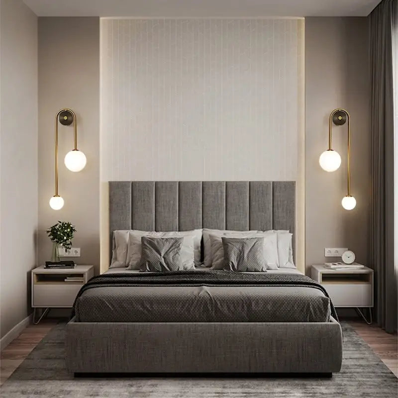 Gray upholstered bed with tufted headboard and matching mattress cover from decorbites featuring elegant gold wall sconces