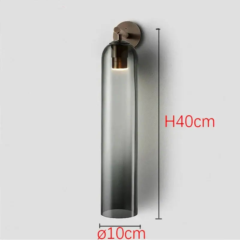 Sleek glass wall sconce with dark smoked glass shade and brushed brass hardware compatible with energy-efficient led bulbs