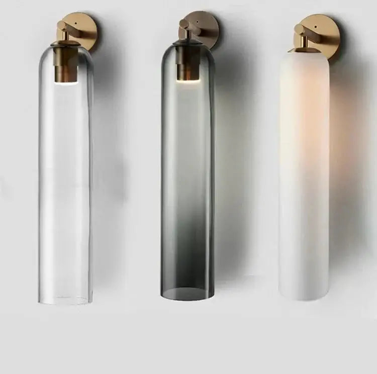 Three sleek glass wall sconces by decorbites with brass fixtures and clear smoked gray and frosted white shades for energy-efficient led bulbs