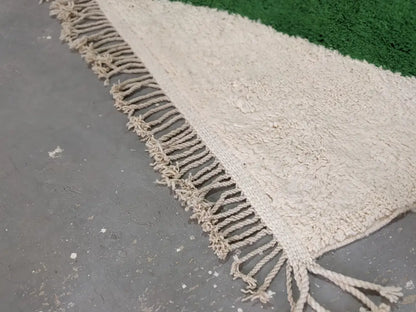 Cream-colored traditional azilal rug with textured wool, fringed edge, and green border by DecorBites™ 298x220cm