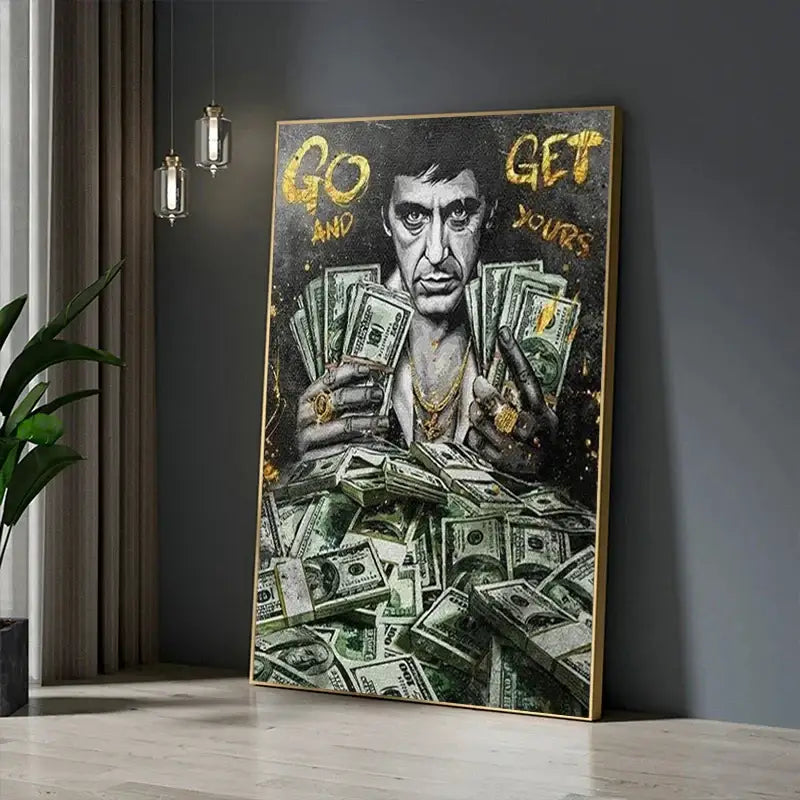 A framed canvas painting of scarface tony montana in black and gold holding stacks of money decorbites motivational art