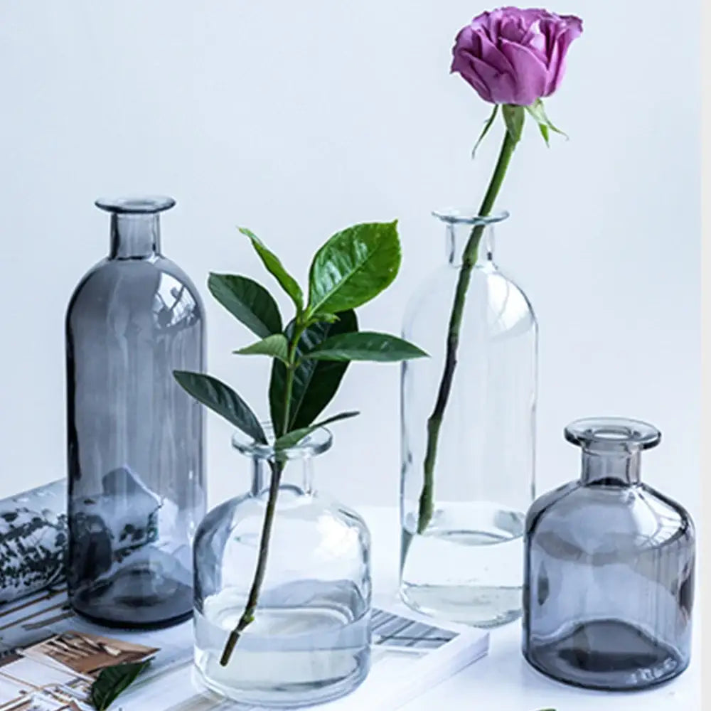 A collection of clear and smoky gray glass vases with simple elegant designs ideal as a flower pot or glass vase with opening 2cm