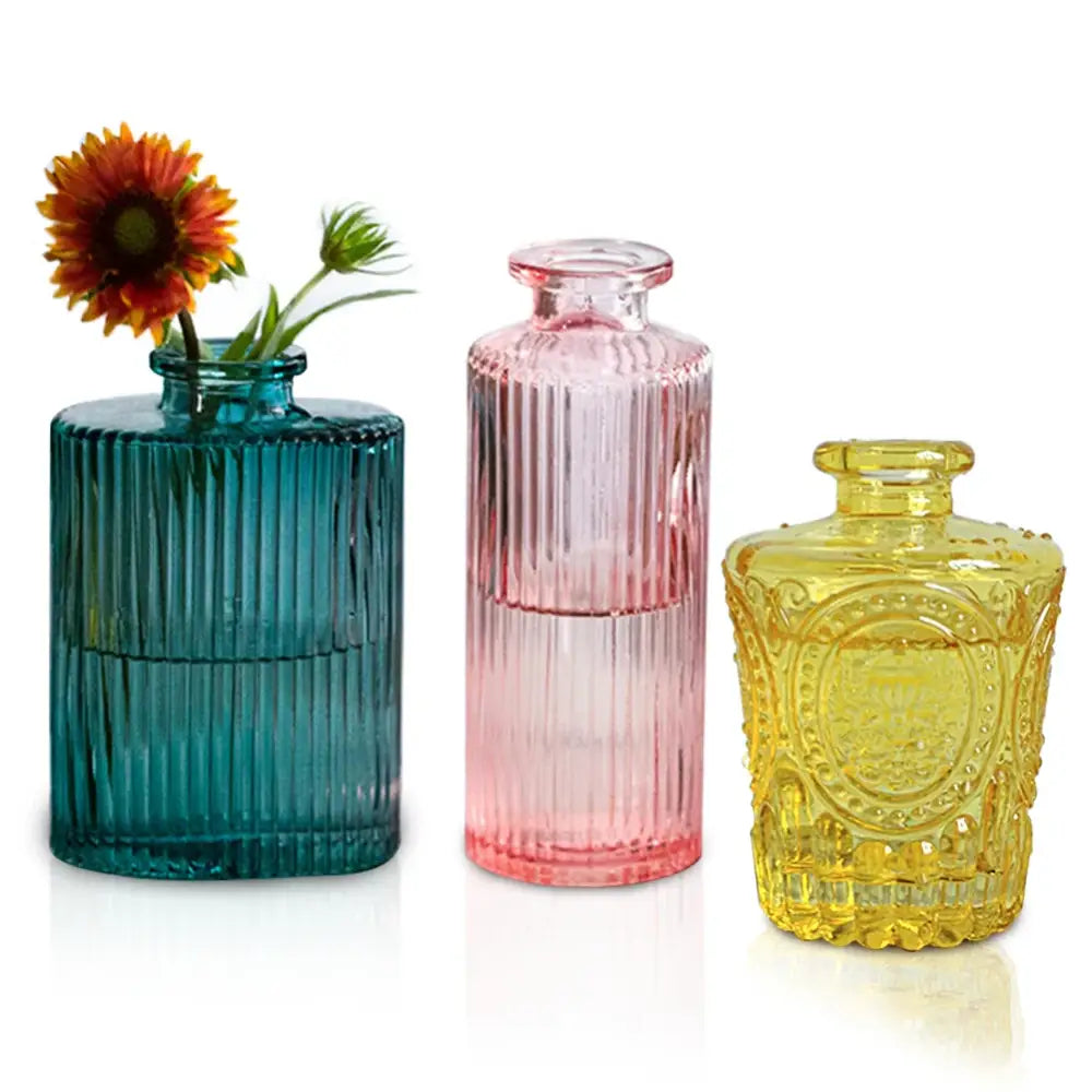 Set of three colorful teal pink and yellow ribbed glass vases with 2cm opening for use as flower pots by decorbites