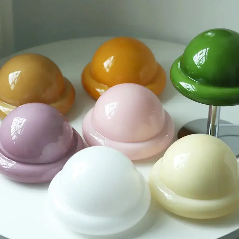 Pastel-colored glossy resin planet-shaped decorative objects complement the decorbites™ mushroom table lamp