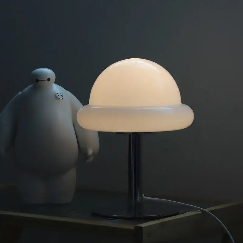 Decorbites™ mushroom table lamp with glowing off-white plastic shade and black metal base in bauhaus style