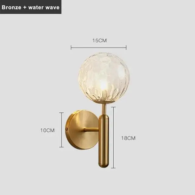Bronze-finished DecorBites Mynte wall sconce with textured translucent glass globe featuring intricate water wave pattern