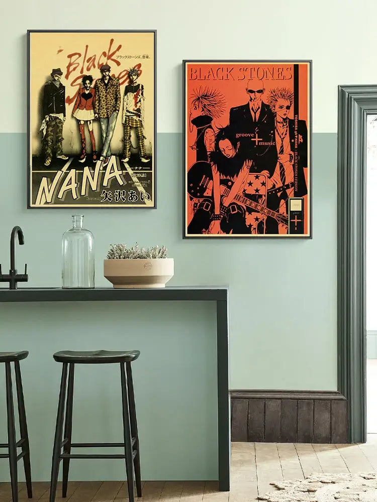 Two retro kraft framed posters above kitchen counter featuring black stones and nana anime characters designs