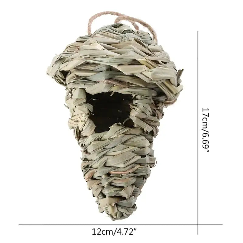 A woven light beige natural grass bird cage with a twine hanging loop in decorbites style birds nest design