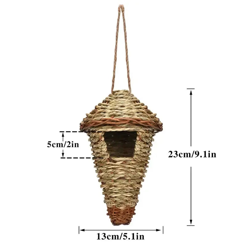 Handwoven natural grass bird cage with conical shape and woven entrance for parrot nest hanging by rope