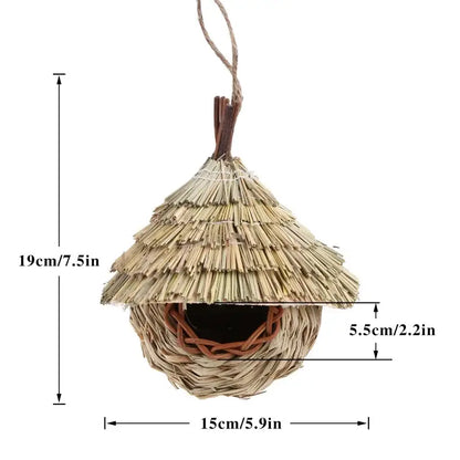 Handwoven natural grass bird cage with thatched roof and wooden dowels for hanging parrot nest by DecorBites