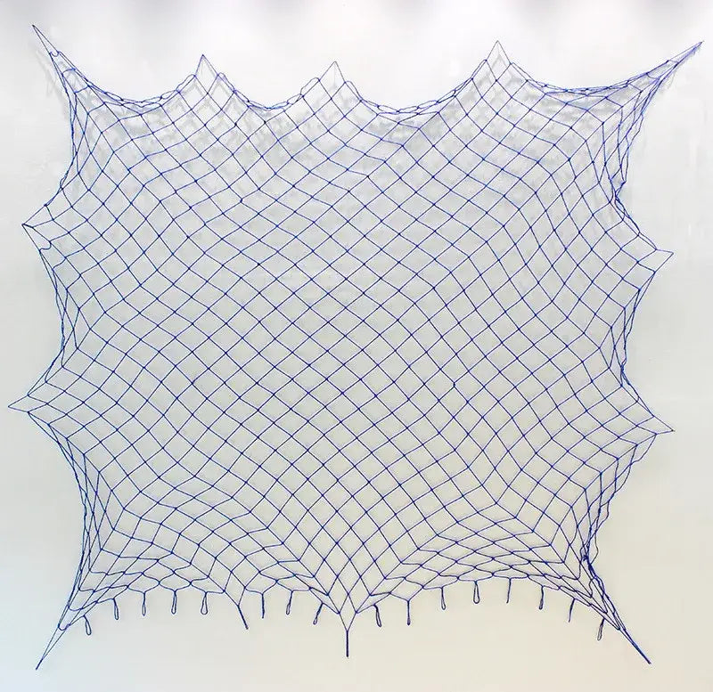 DecorBites™ nautical theme wall decor featuring a blue diamond-patterned fishing net decoration with tassels and scalloped edge