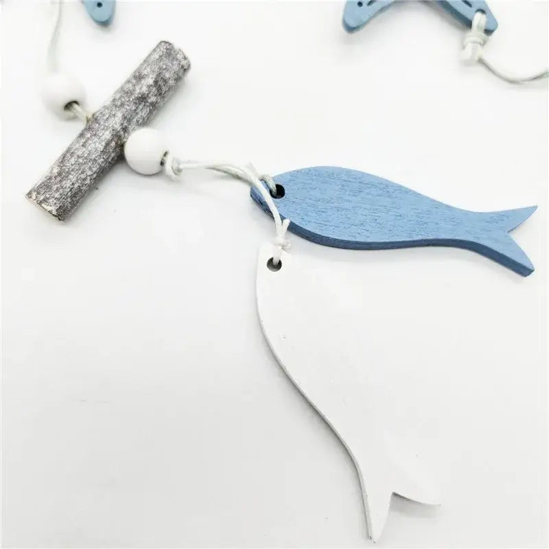Decorbites™ nautical theme wall decor featuring blue and white wooden fish-shaped fishing net decoration strung with white cord