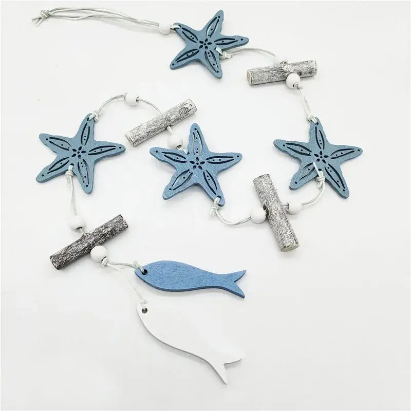 Decorbites™ nautical theme wall decor featuring blue and white wooden garland with starfish fish and driftwood accents