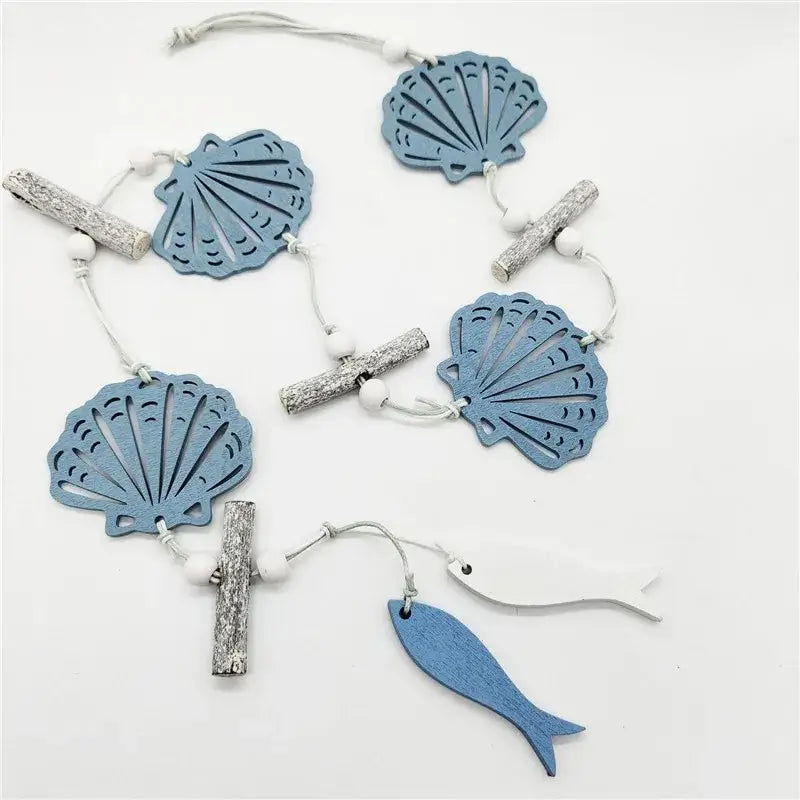 DecorBites™ nautical theme wall decor with blue wooden shell and fish ornaments strung with white beads and driftwood sticks perfect for fishing net decoration