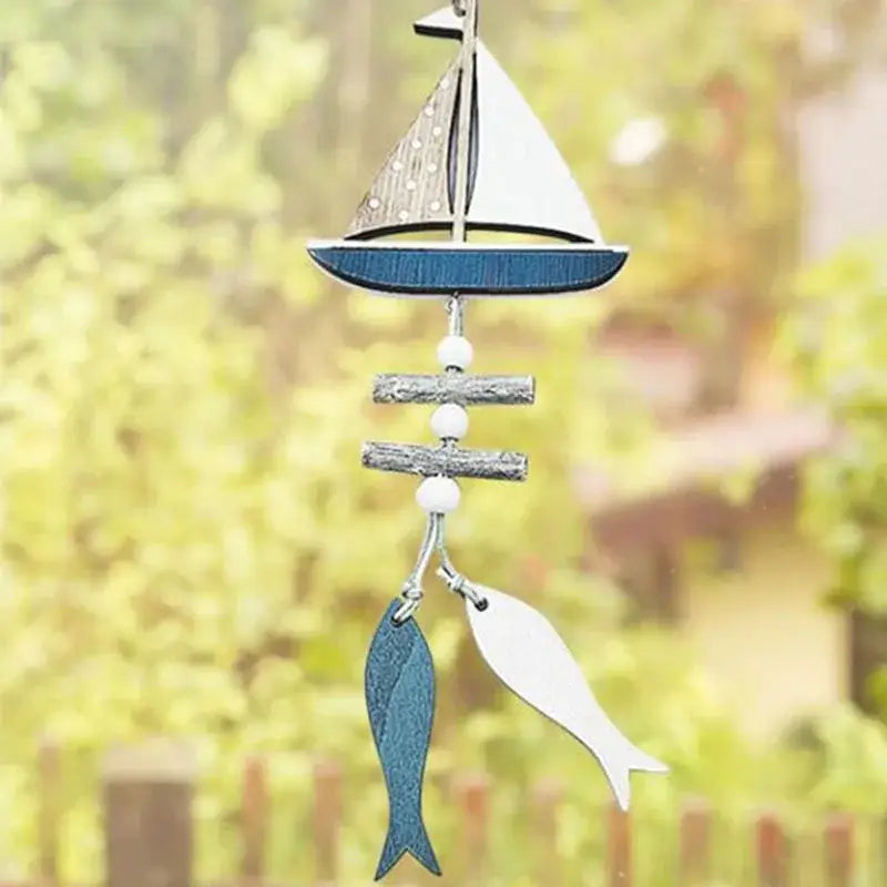 Decorbites™ nautical theme wall decor wind chime with wooden sailboat, fishing net decoration, teal leather, and white fish charms
