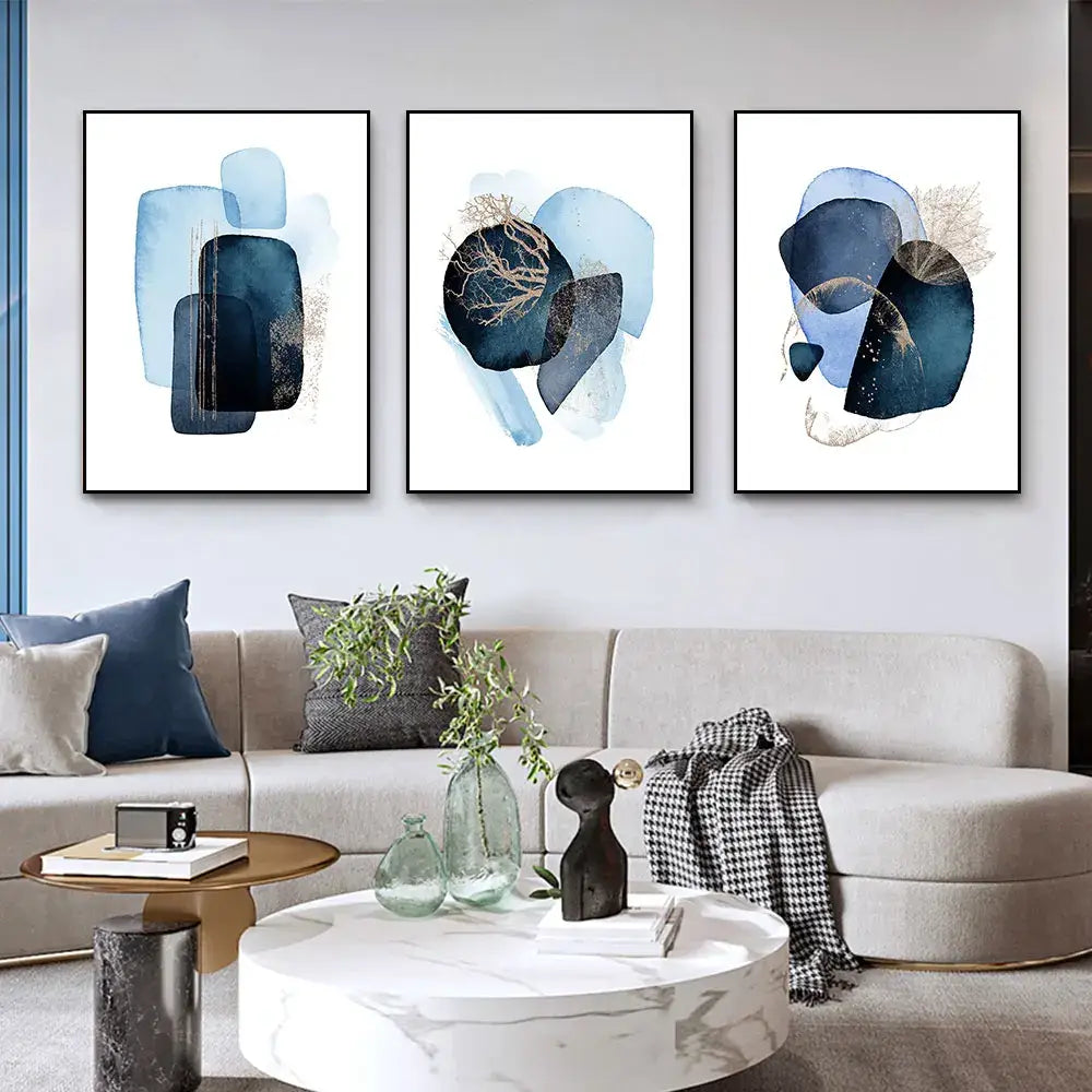 Set of three DecorBites™ navy blue geometric wall art pieces with layered shapes and gold leaf accents in frames