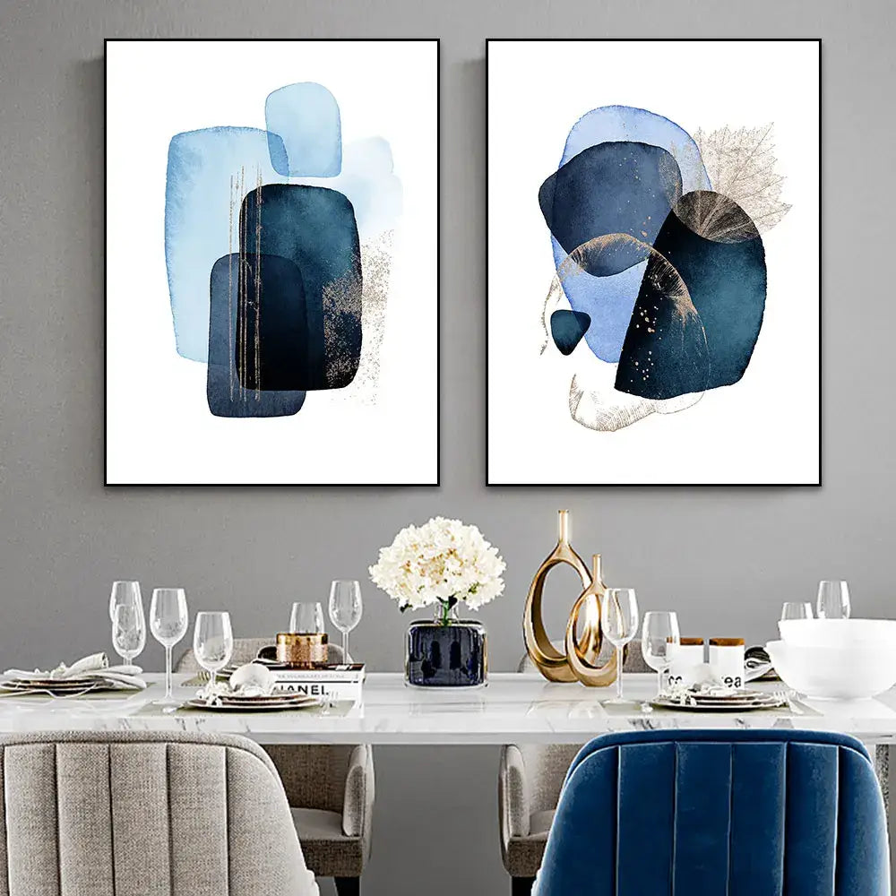 Two framed decorbites™ navy blue geometric wall art paintings with layered shapes and gold accents above dining table