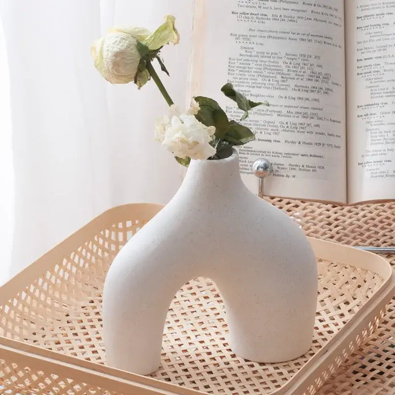 A nordic ceramic flower vase by DecorBites with an off-white sleek design and a metallic silver knob for home decor