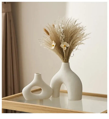 A sleek off-white nordic ceramic vase with a modern arched base and smooth curves for vases home decor