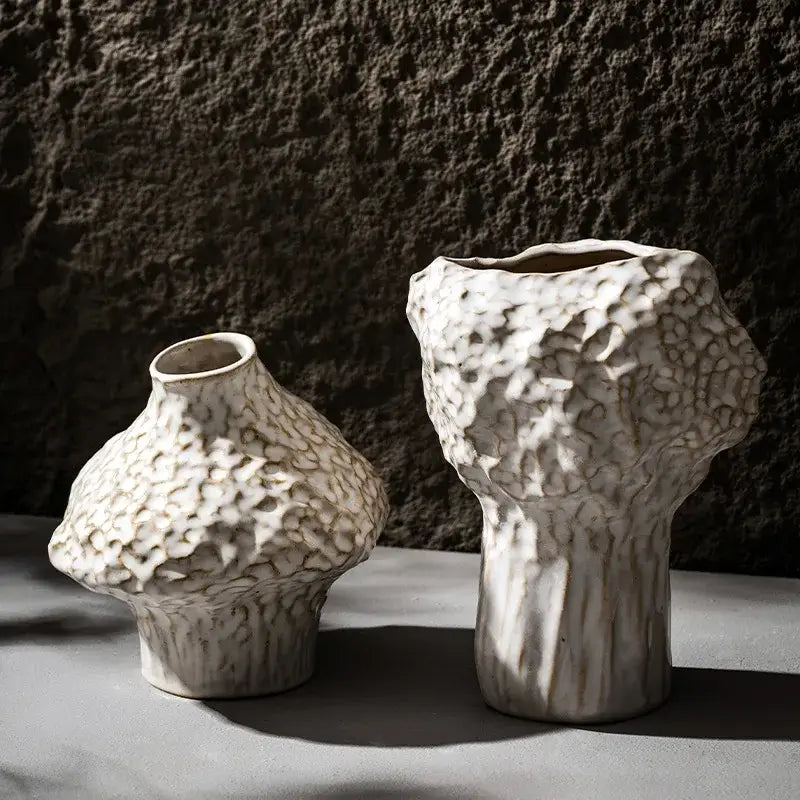 Two off-white nordic ceramic vases with textured pebbled surface and organic asymmetrical shapes for pampas grass