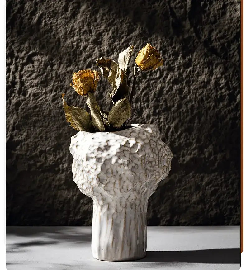White ceramic nordic ceramic vase with textured surface holding dried yellow roses from DecorBites pampas grass collection